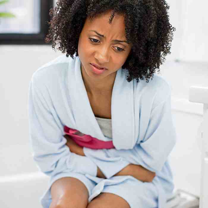 woman-holding-heating-pad-on-stomach